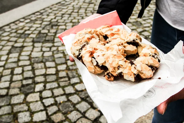 Fresh German pretzels with sea salt close-up on dark black board — Stock Photo, Image