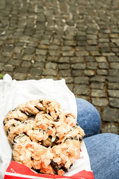 Fresh German pretzels with sea salt close-up on dark black board — Stock Photo, Image