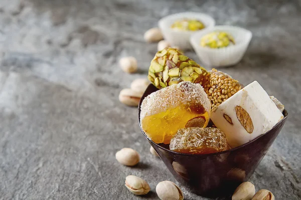 Eastern sweets. Turkish delight with pistachios in a vase. Dark