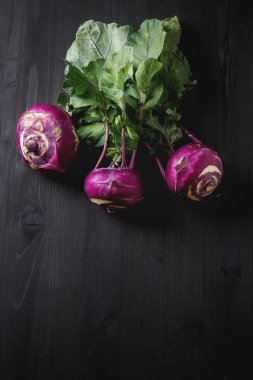 Yeşil yaprakları ile olgun mor şalgam. Koyu arka plan. Sonbahar p