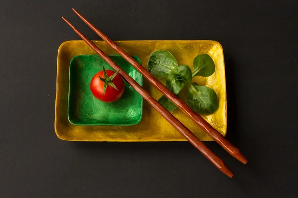 Diet for girls. lettuce and tomato on a platter — Stock Image Diet for girls. lettuce and tomato on a platter Royalty Free Stock Images