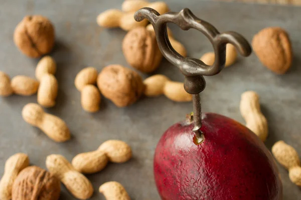 Juicy red mango. with corkscrew and nuts — Stock Photo, Image