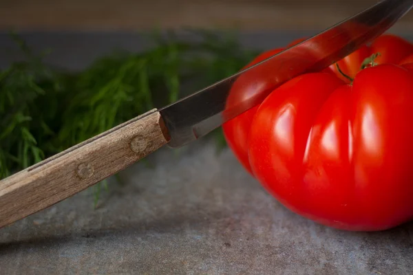 Tomato with avocado and garlic with dill. on wood background — Stock Image Tomato with avocado and garlic with dill. on wood background Stock Picture