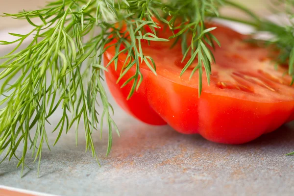 Tomato with avocado and garlic with dill. on wood background — Stock Image Tomato with avocado and garlic with dill. on wood background Stock Image