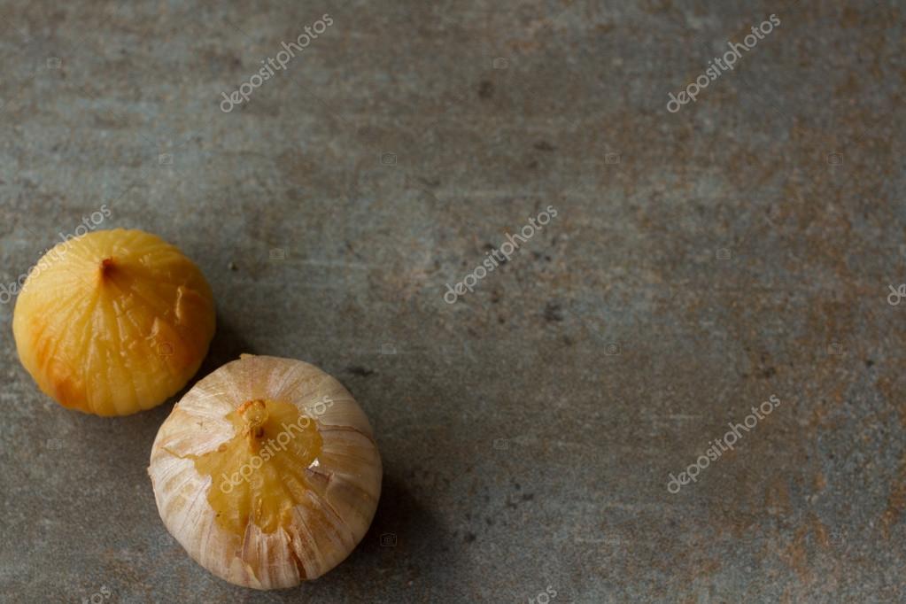Roasted garlic on a gray background. Dietary cuisine