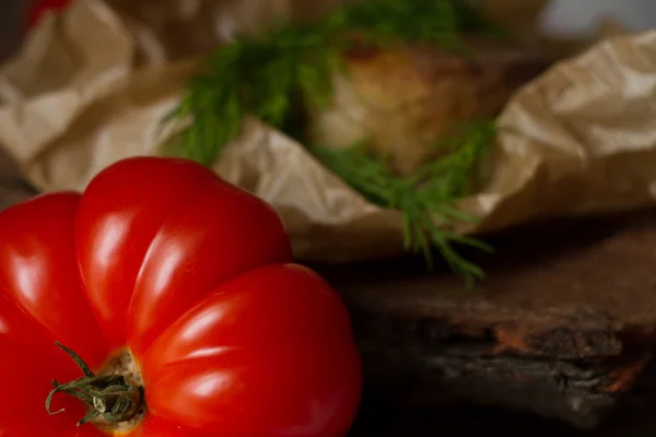 Tomatoes with hazelnuts wood texture as a basis — Stock Photo, Image