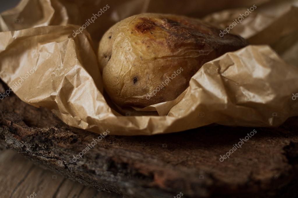Baked potatoes on the grill. wrapped in baking paper