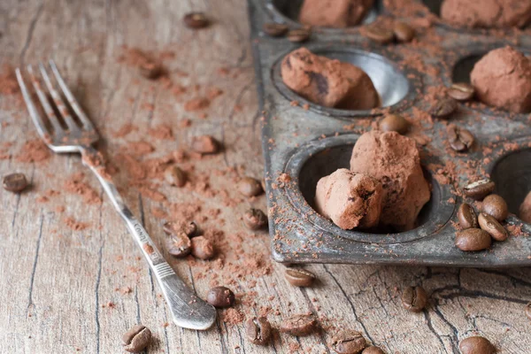 Chocolate truffles in an unusual shape with metal cutlery — Stock Photo, Image