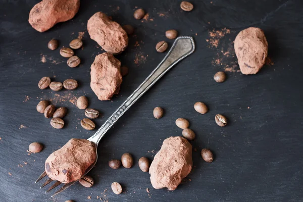 Chocolate truffles in an unusual shape with metal cutlery — Stock Photo, Image