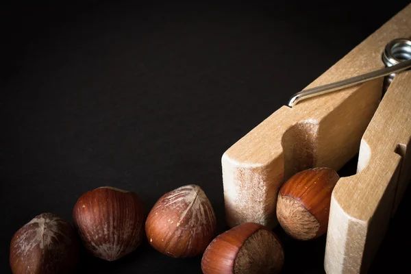 Hazelnuts in shell with clothespins — Stock Photo, Image