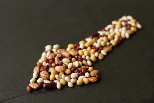 Beans and peas on a black stone — Stock Photo, Image