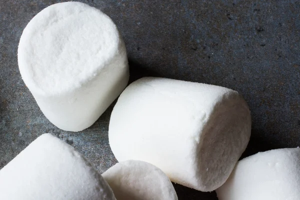White marshmallow pieces on wood background — Stock Photo, Image