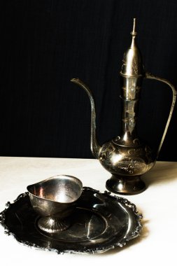 metal jug and a plate in oriental style