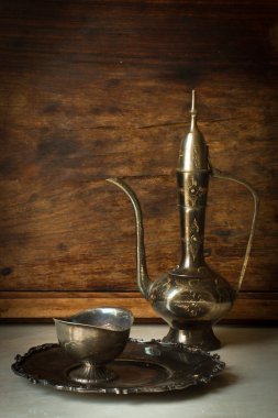 metal jug and a plate in oriental style