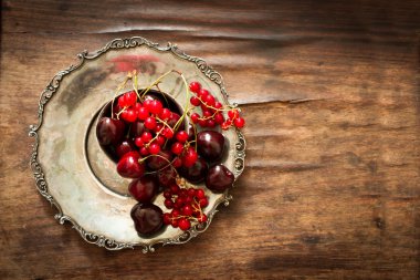 sweet cherry with a metal pitcher and dish in oriental style 