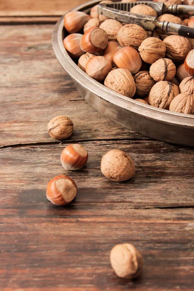 mixture of nuts on metal plates with vintage orehokolom