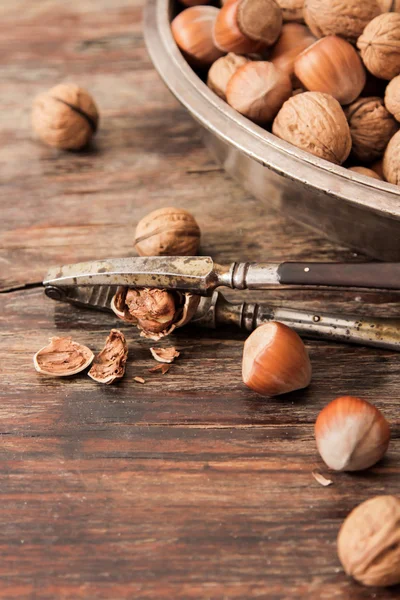 mixture of nuts on metal plates with vintage orehokolom