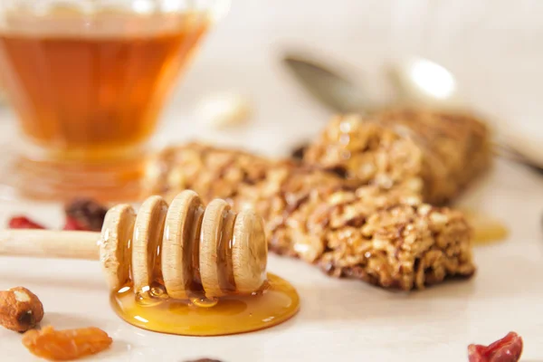 Bar of delicious muesli with honey and nuts — Stock Photo, Image