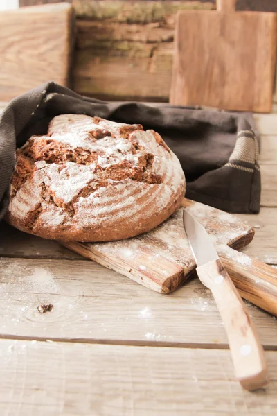 Fresh bread and salt on a wooden background — Stock Photo, Image