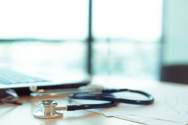 Doktorun ofisindeki dizüstü bilgisayarda tıbbi steteskop.
