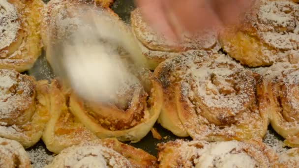 Sifting icing sugar onto buns — Stock Video