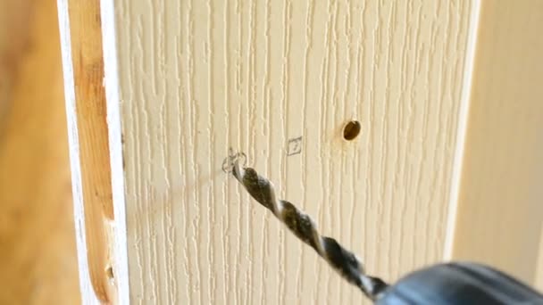 Τοποθέτηση ενός κλειδώματος πόρτας τρύπες σε μια λευκή πόρτα — Αρχείο Βίντεο
