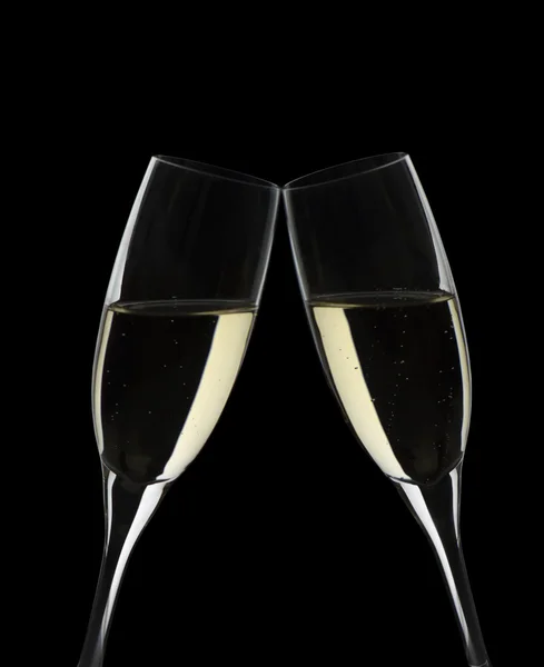 two glasses with sparkling wine on black background