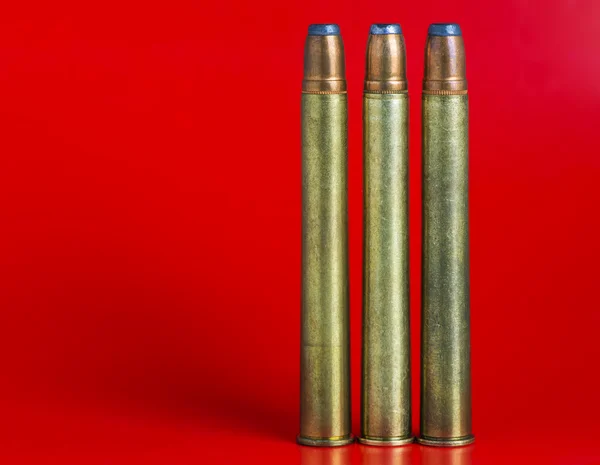 Cartridges for rifled arms on a red background — Stock Photo, Image