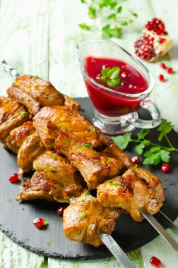Grilled pork ribs on skewers. Barbecuing lunch clipart