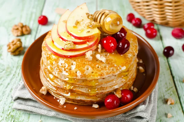 Homemade pancakes with honey, apple, cranberries and nuts — Stock Photo, Image