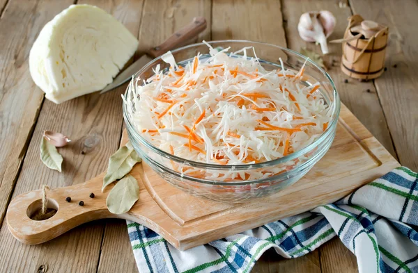 Fresh cabbage prepared for pickling on woodboard — Stock Photo, Image