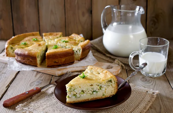 Pie with onions and eggs on the wooden table — Stock Photo, Image