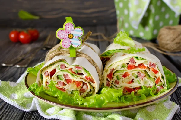 Rolls of bread with vegetables, cheese and sausage