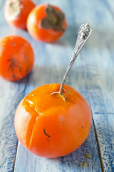 Ripe sweet persimmons on wooden table — Stock Photo, Image