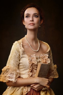 Portrait of woman in historical dress with a book in their hands clipart