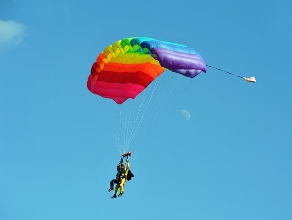 Tandem parachute against clear blue sky