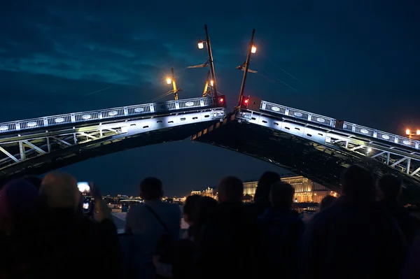 Nacht fokken brug in Sint-Petersburg. Veel mensen op zoek van schip onder de brug Stockfoto