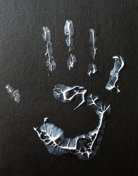 fat human hand imprint on black background