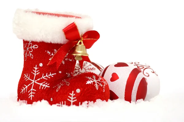 Christmas background with Santa's red boot and baubles in snow on white — Stock Photo, Image