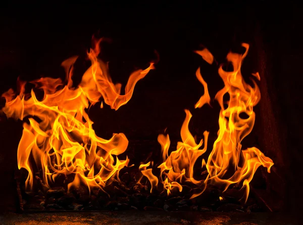 Fire in a oven, two flames on the black background — Stock Photo, Image