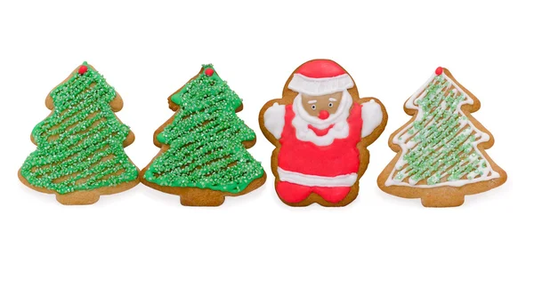 Galletas de Navidad con Santa y árboles aislados en blanco — Foto de Stock