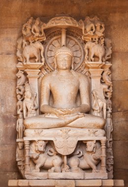 The Jain's statue on a throne made of sandstone. clipart