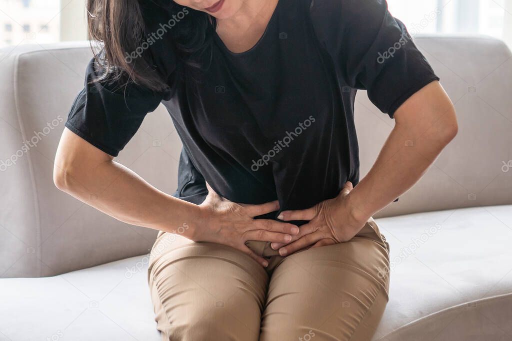 Abdominal pain in woman with stomachache illness from menstruation cramps, stomach cancer, irritable bowel syndrome, pelvic discomfort, Indigestion, Diarrhea or GERD (gastro-esophageal reflux disease)