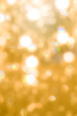 Tatil partisinin kristal küresinin parlak ışığının bulanık sarı arka planı.