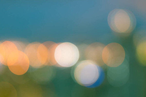 Blur background rooftop view of Bangkok downtown city lights skyline with colorful night bokeh