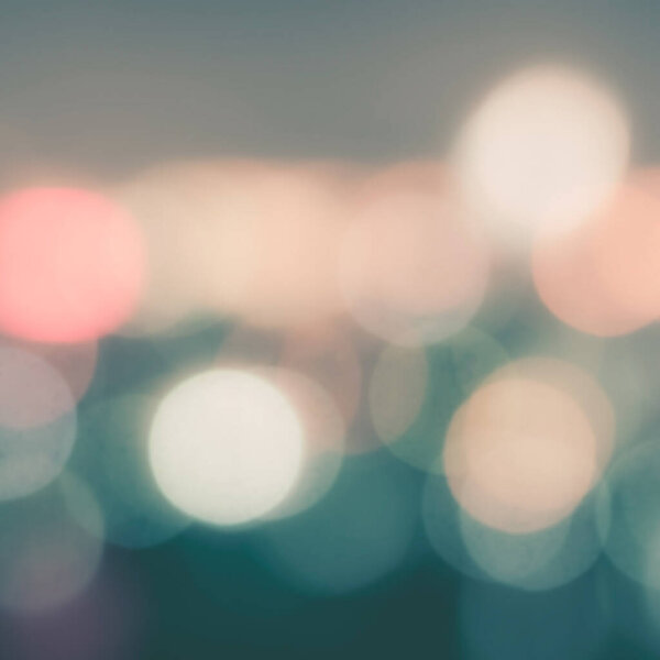 Blur background of night city life with lights bokeh in cool vintage color