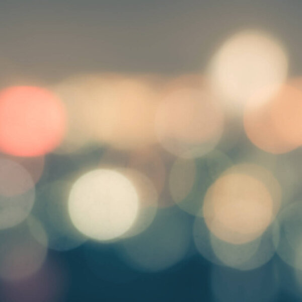 Blur background of night city life with lights bokeh in cool vintage color
