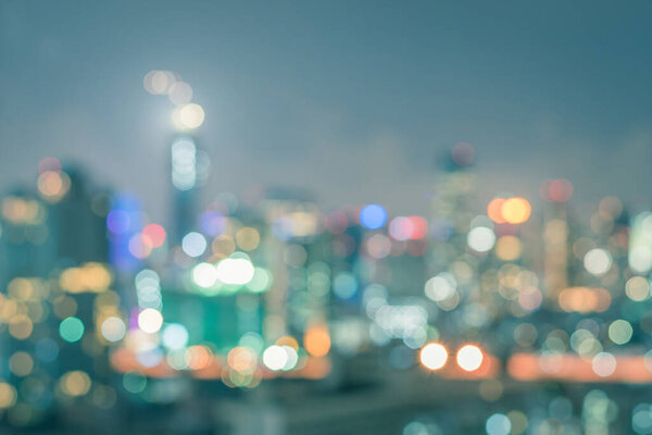 Blur city background rooftop view of Bangkok cityscape business building landscape night lights bokeh with film effects