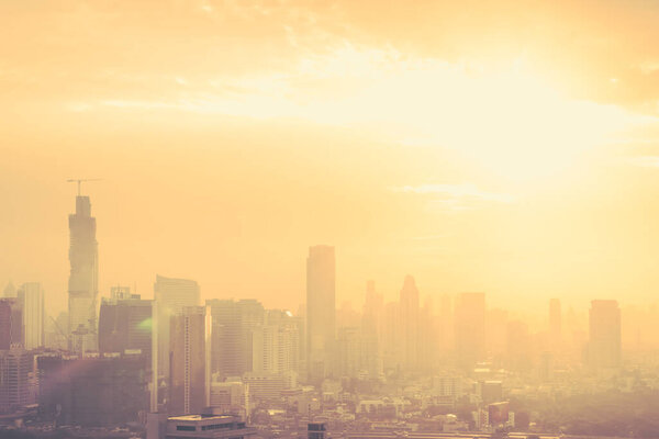 Blur background of morning light on sky with bokeh and sun flare at Bangkok city night life