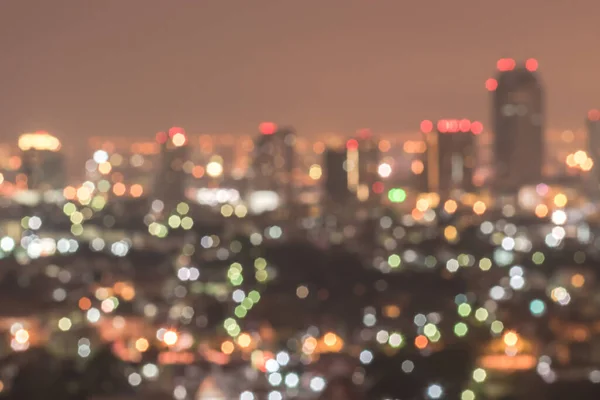 Blur city background rooftop view of Bangkok cityscape business building landscape night lights bokeh